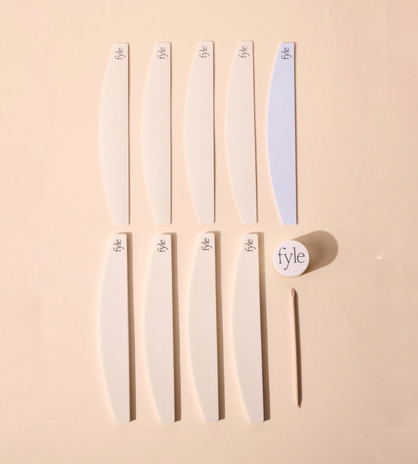 Set of fyle branded nail files on a beige background