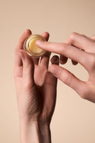Close-up of applying Fyle Cuticle Sealing Balm to the cuticles.