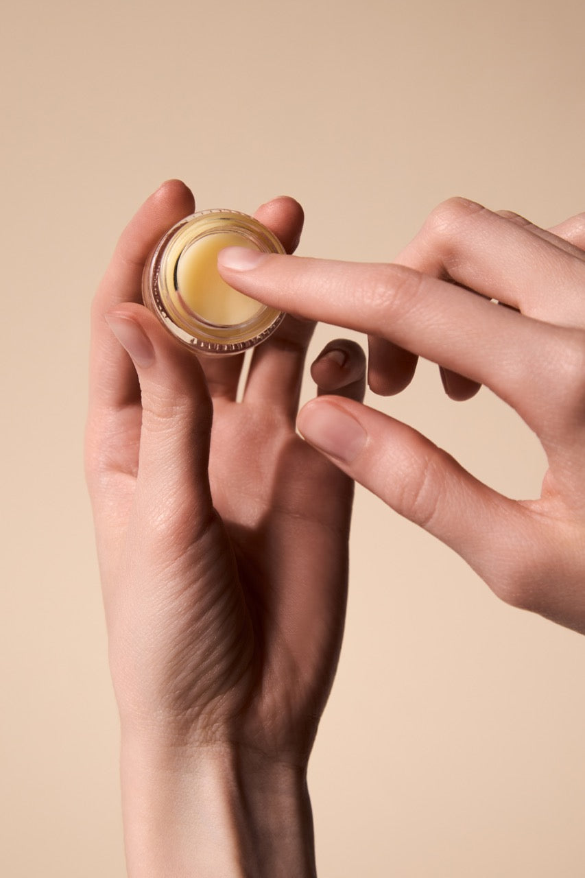 Close-up of applying Fyle Cuticle Sealing Balm to the cuticles.