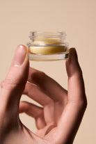 Open jar of Fyle Cuticle Sealing Balm showing smooth natural texture.
