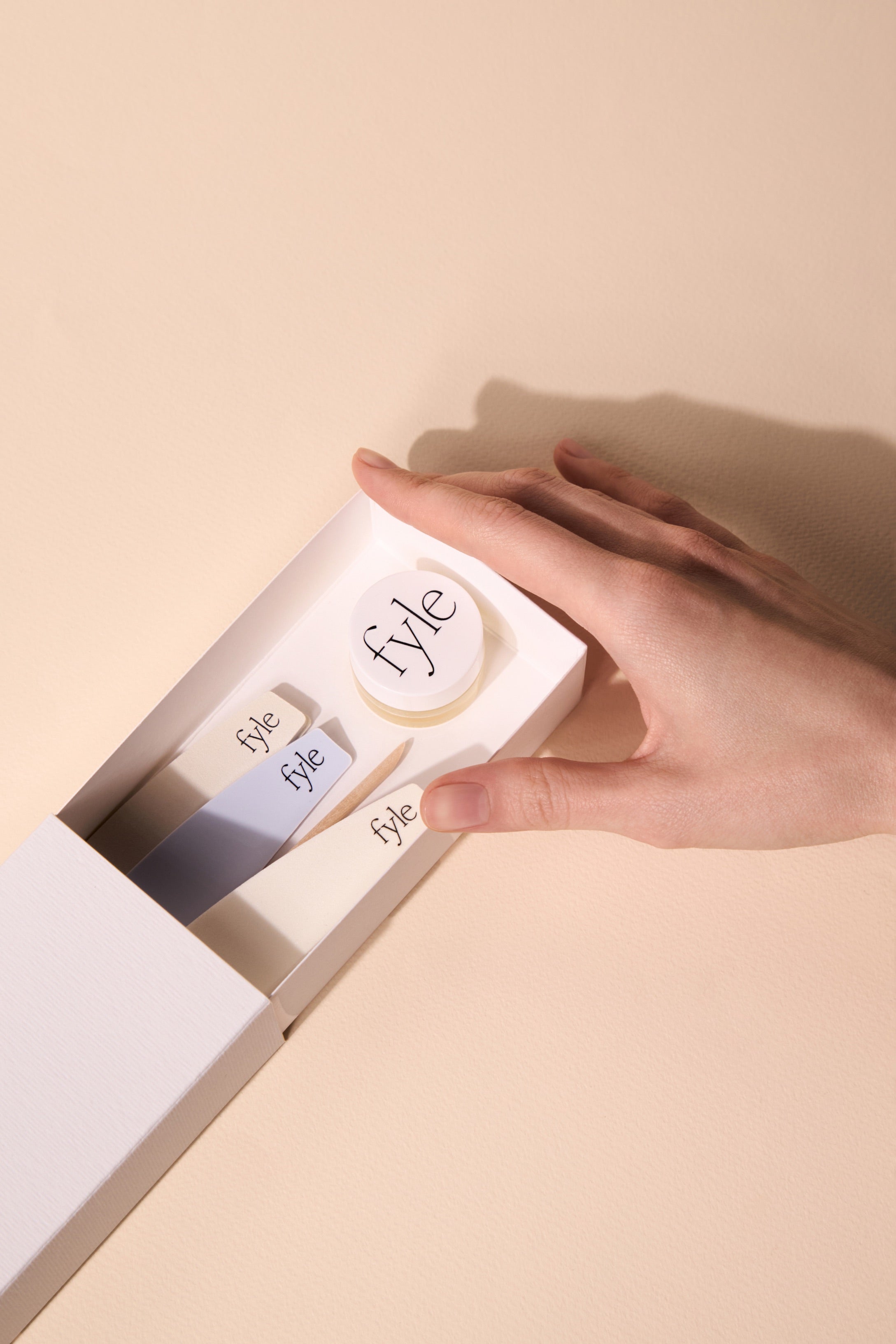 Opening the Fyle File Manicure Kit to reveal the nail care tools inside.